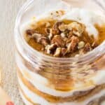 A closeup of a pumpkin yogurt parfait in a jar.