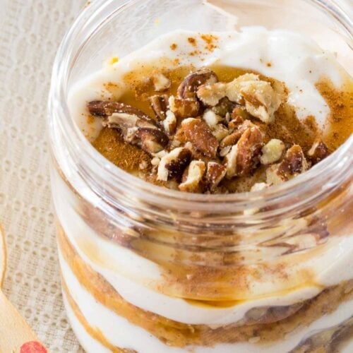 A closeup of a pumpkin yogurt parfait in a jar.