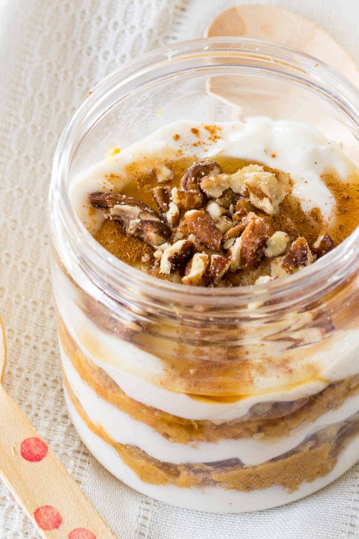 A closeup of a pumpkin yogurt parfait in a jar.