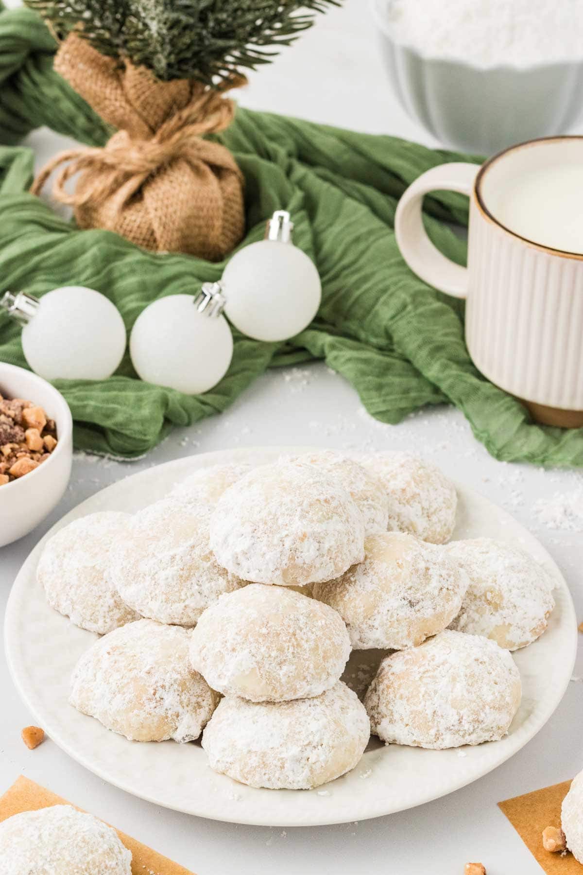 A pile of toffee almond snowball cookies on a plate.