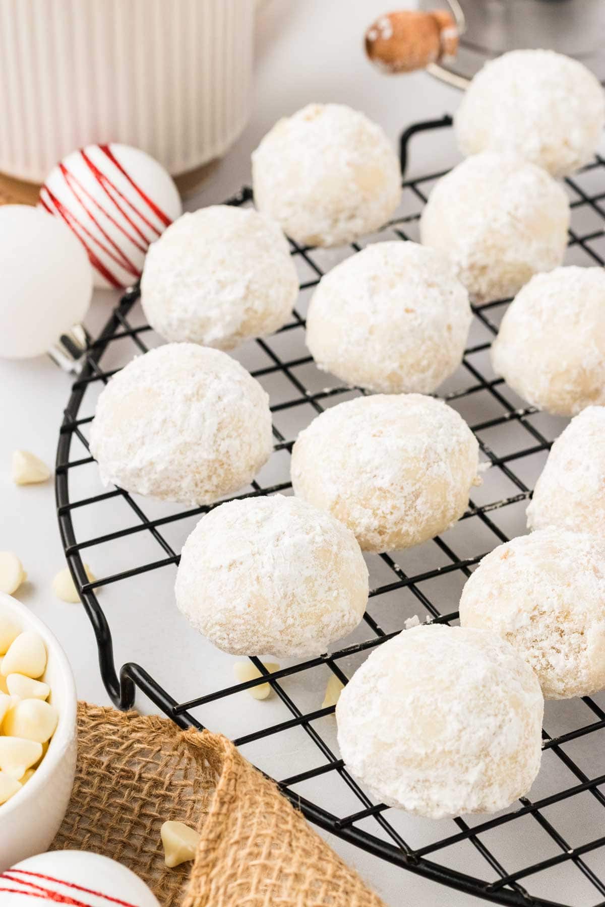 White chocolate macadamia snowball cookies on a wire rack.