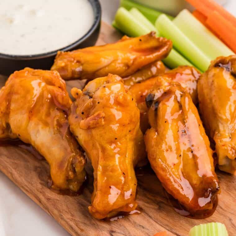 Baked buffalo wings on a cutting board