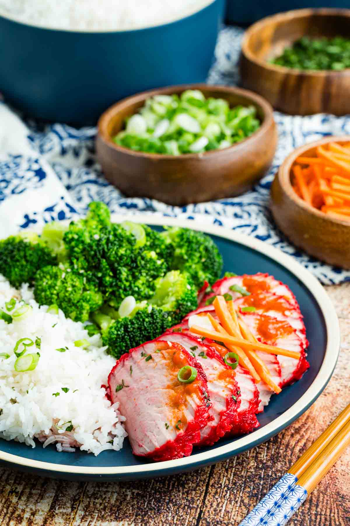 A plate of Char Siu pork with rice and broccoli