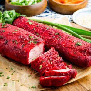 Two Char Siu pork tenderloins on a cutting board