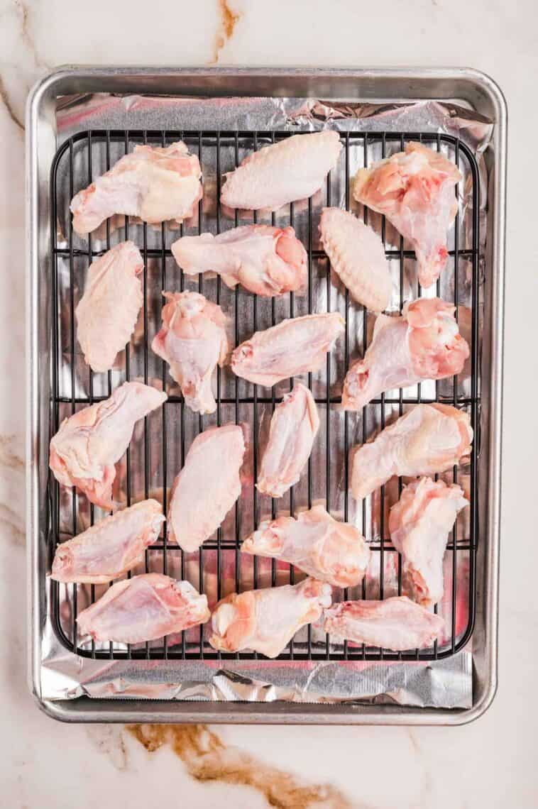 Chicken wings on a wire rack over a baking sheet