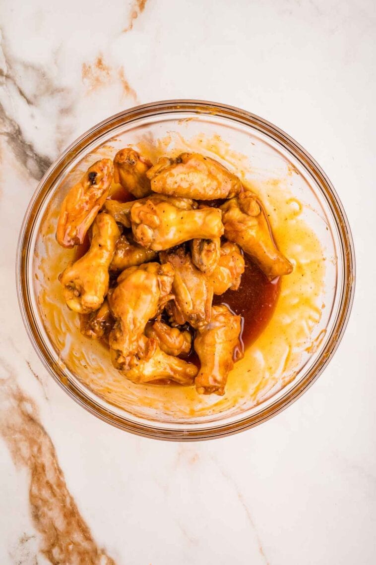 Baked buffalo wings in a glass bowl