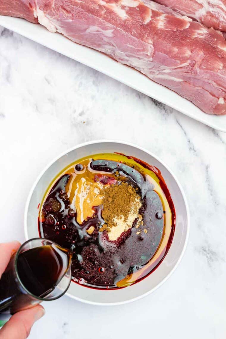 Pouring soy sauce into a mixing bowl