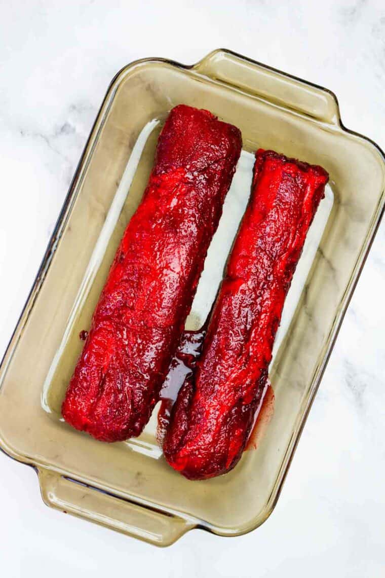 Two pork tenderloins on a baking sheet