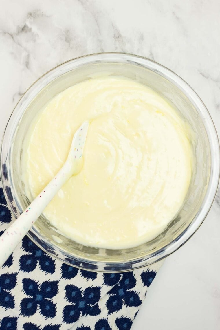 Stirring melted white chocolate chips and sweetened condensed milk