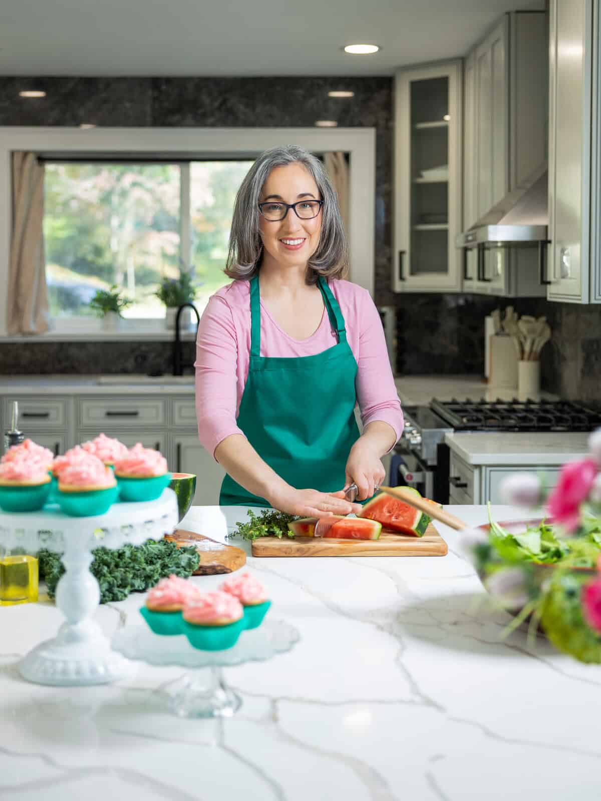 Brianne Izzo preparing ingredients in kitchen while developing gluten-free recipes.
