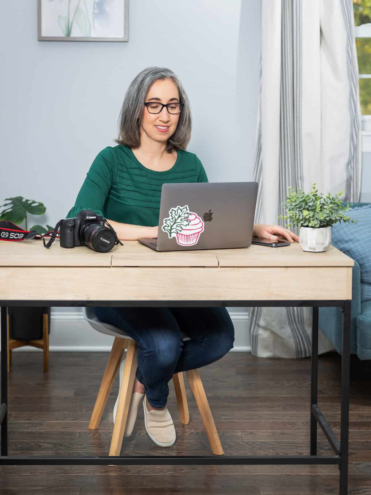Brianne Izzo working at desk on recipe development and photography for gluten-free food blog.