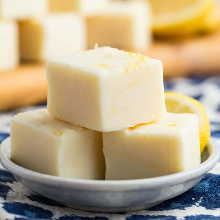 Three pieces of lemon fudge on a white plate