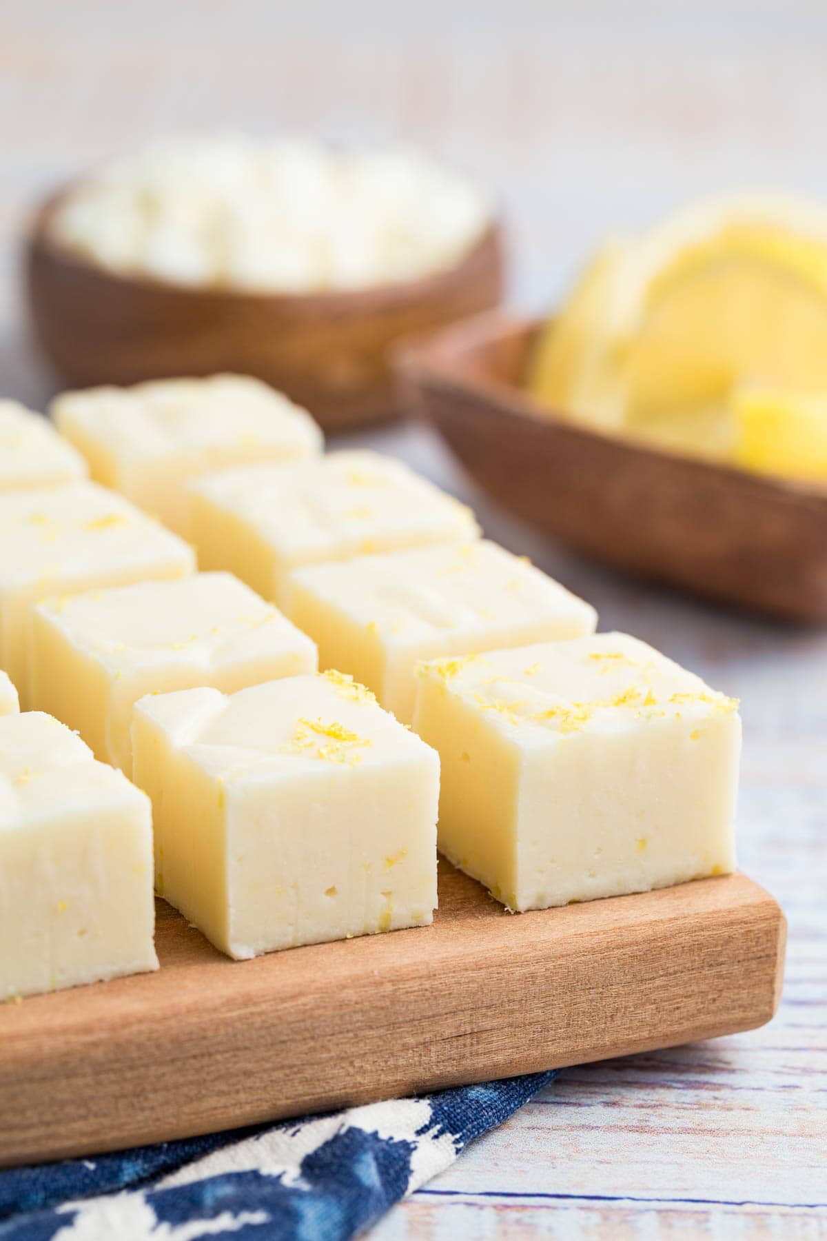 Side view of lemon fudge on a cutting board