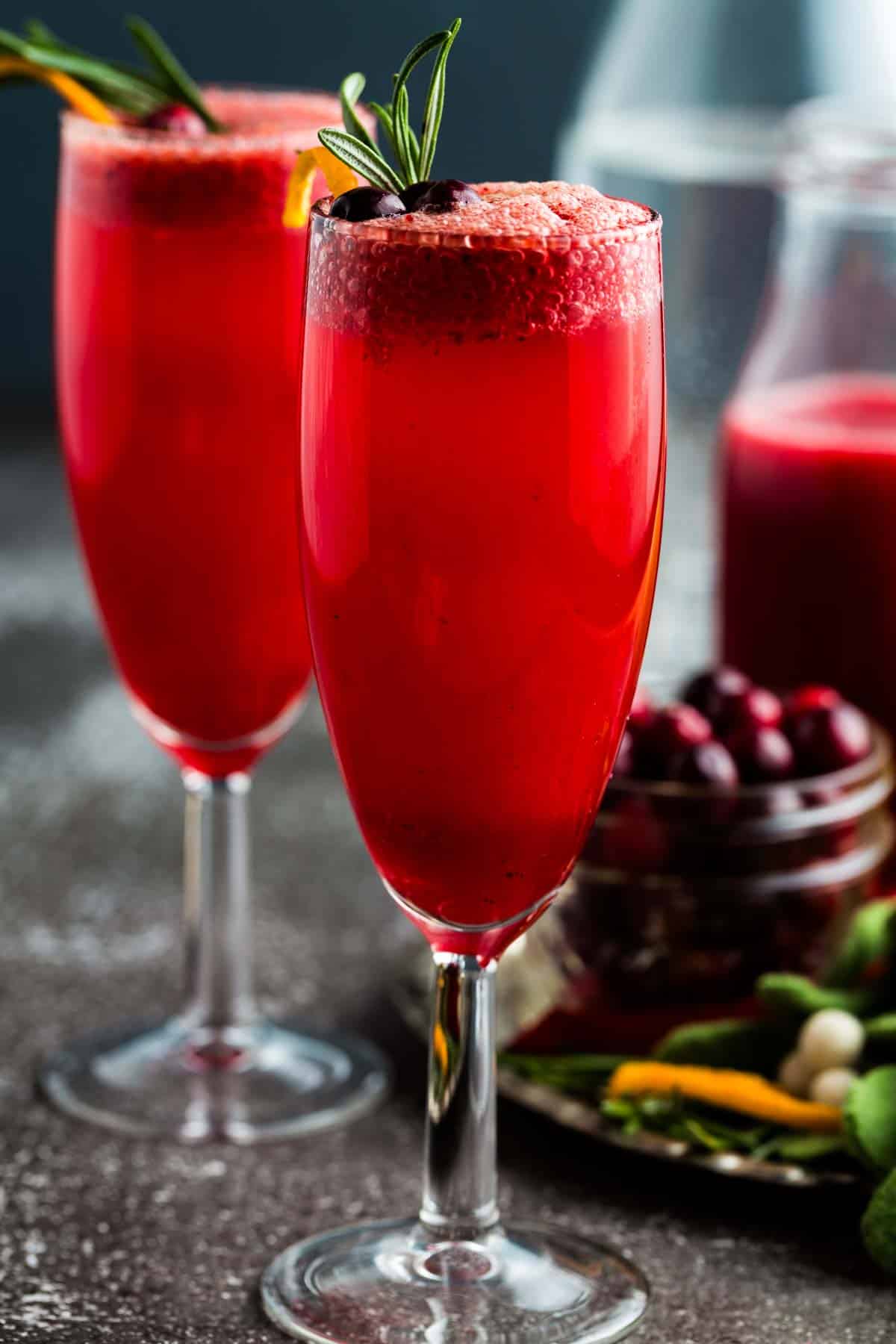 A bright red cranberry mocktail in a flute glass.