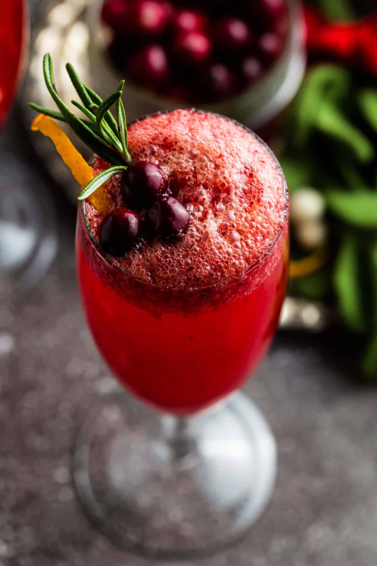 Looking down at the bubbles and garnished on top of a flute glass.