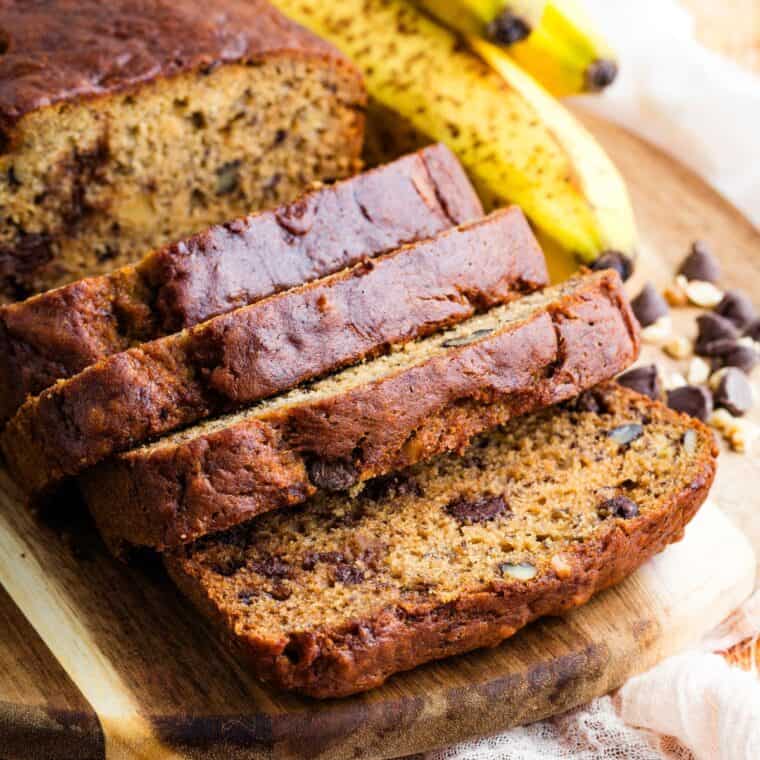 A loaf of chocolate chip banana bread with half sliced