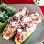 A close-up of the chicken stuffed zucchini topped with feta cheese.