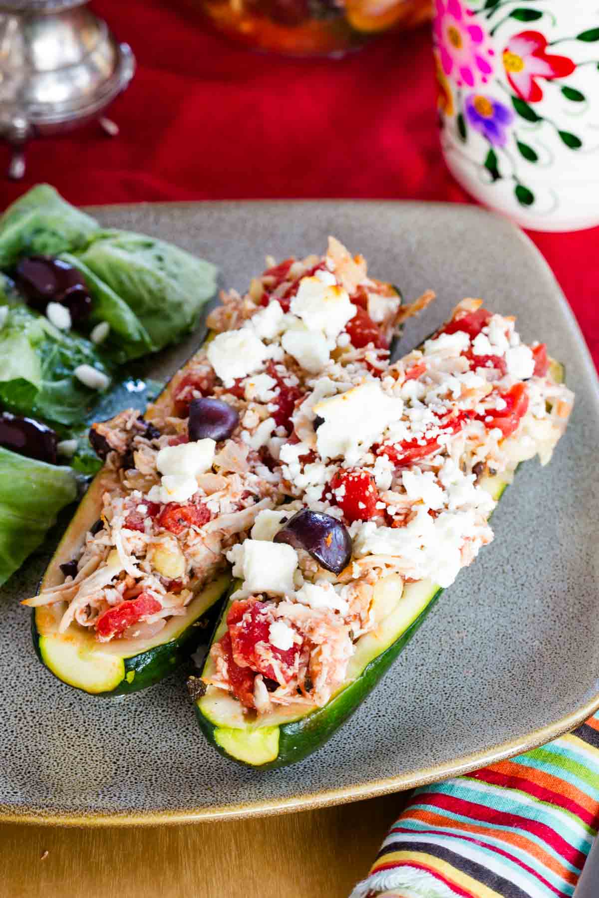 A close-up of the chicken stuffed zucchini topped with feta cheese.