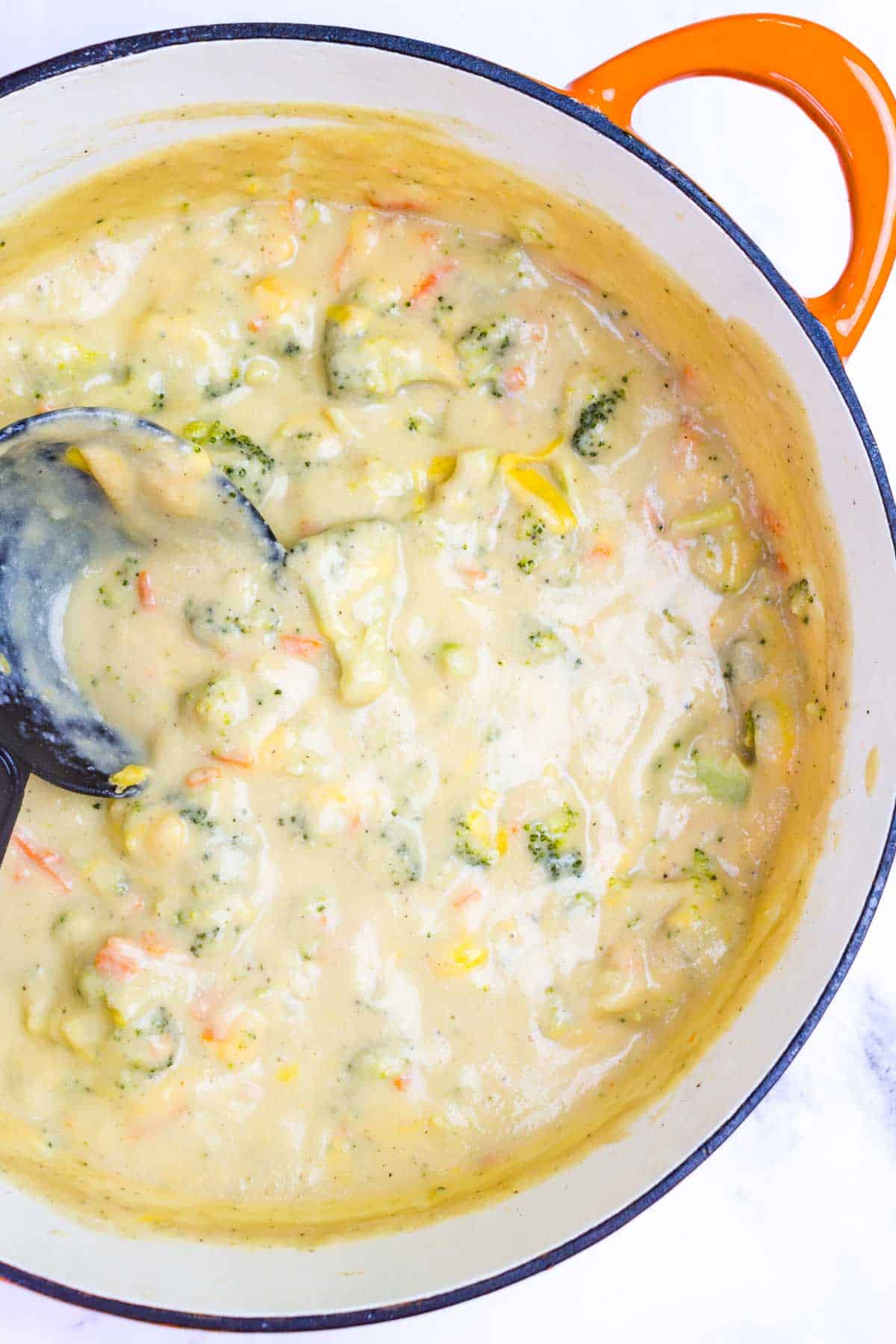 Cheese being stirred into the soup.