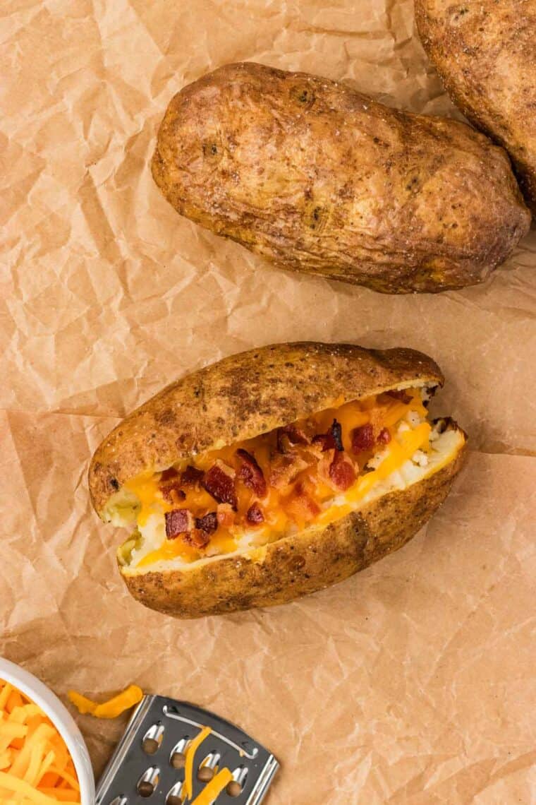 A baked potato with cheese and bacon
