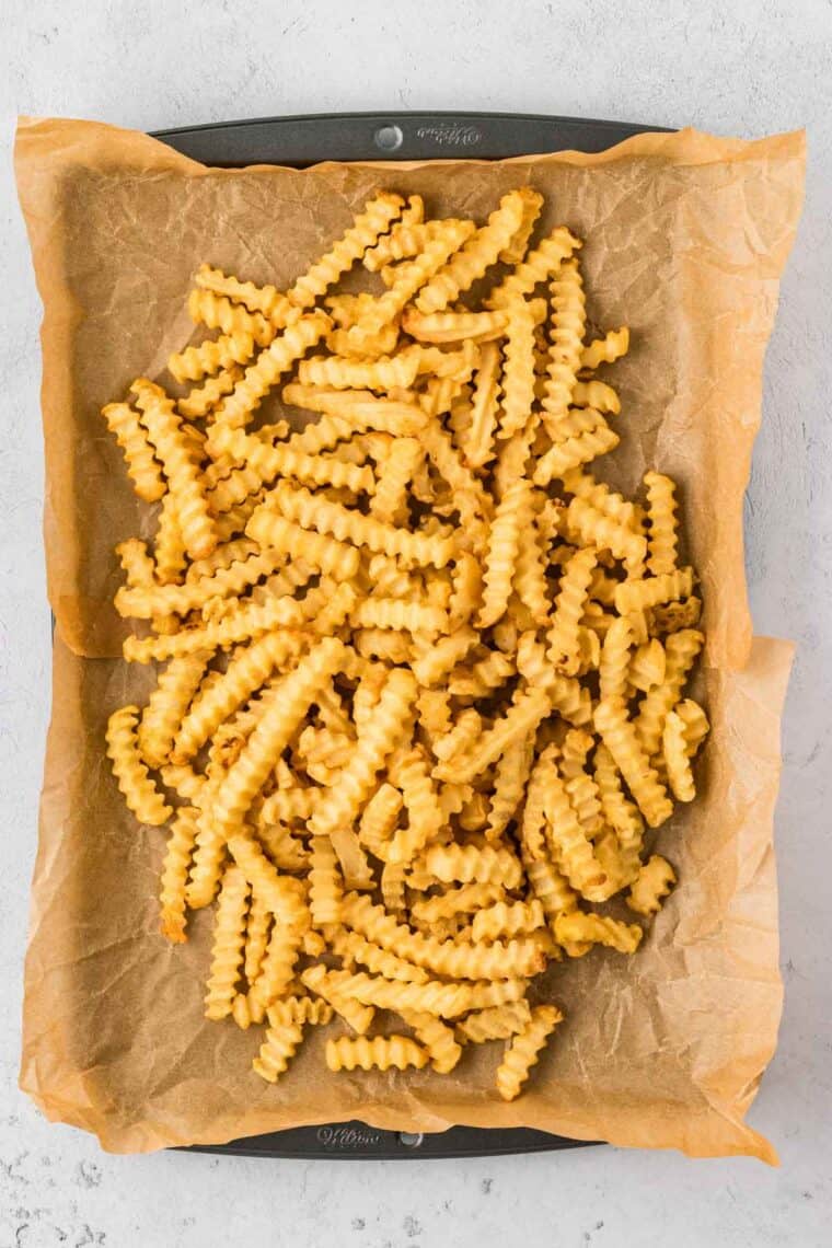 Fries pushed to the center of a baking sheet