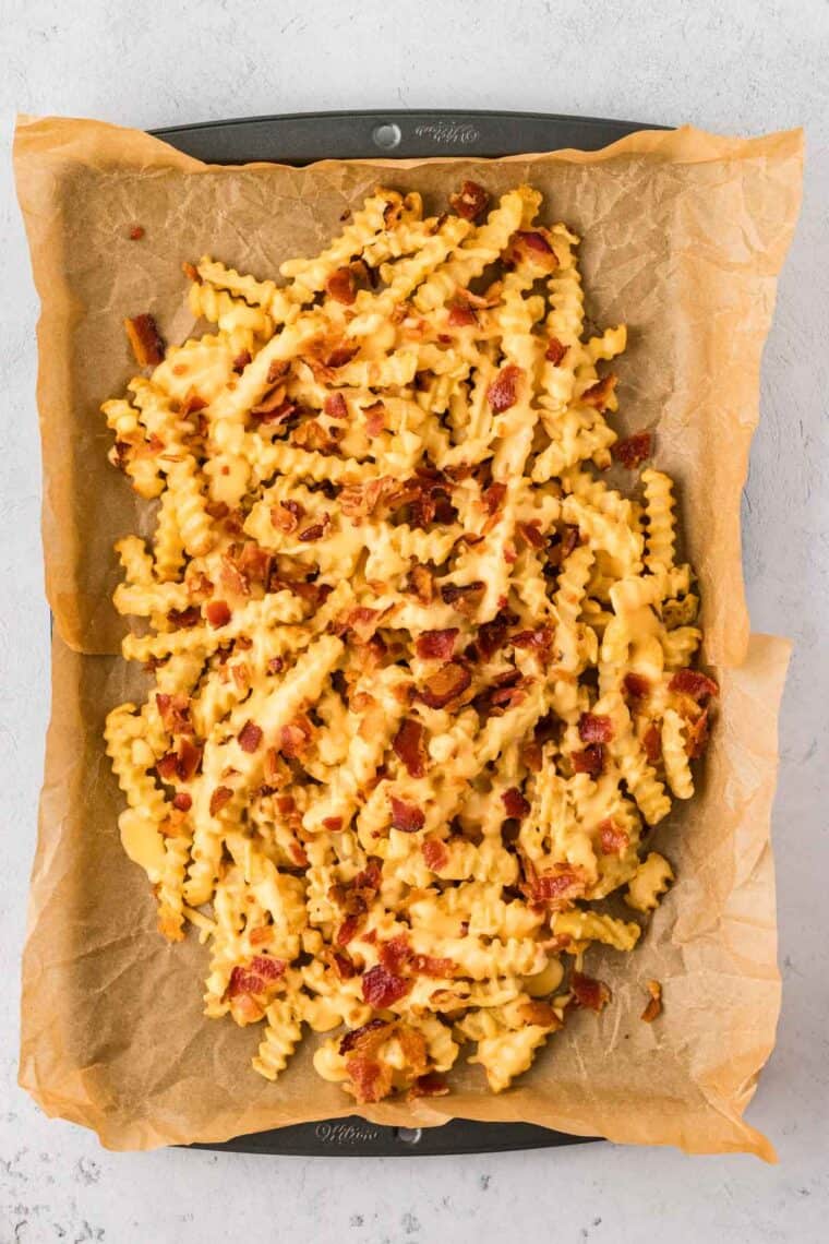 Fries topped with cheese sauce and bacon