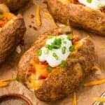 A loaded baked potato on parchment paper