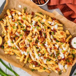 Overhead view of a baking sheet of loaded fries
