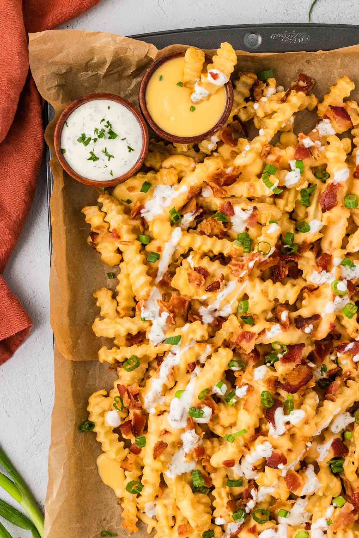 Overhead view of a baking sheet of loaded french fries