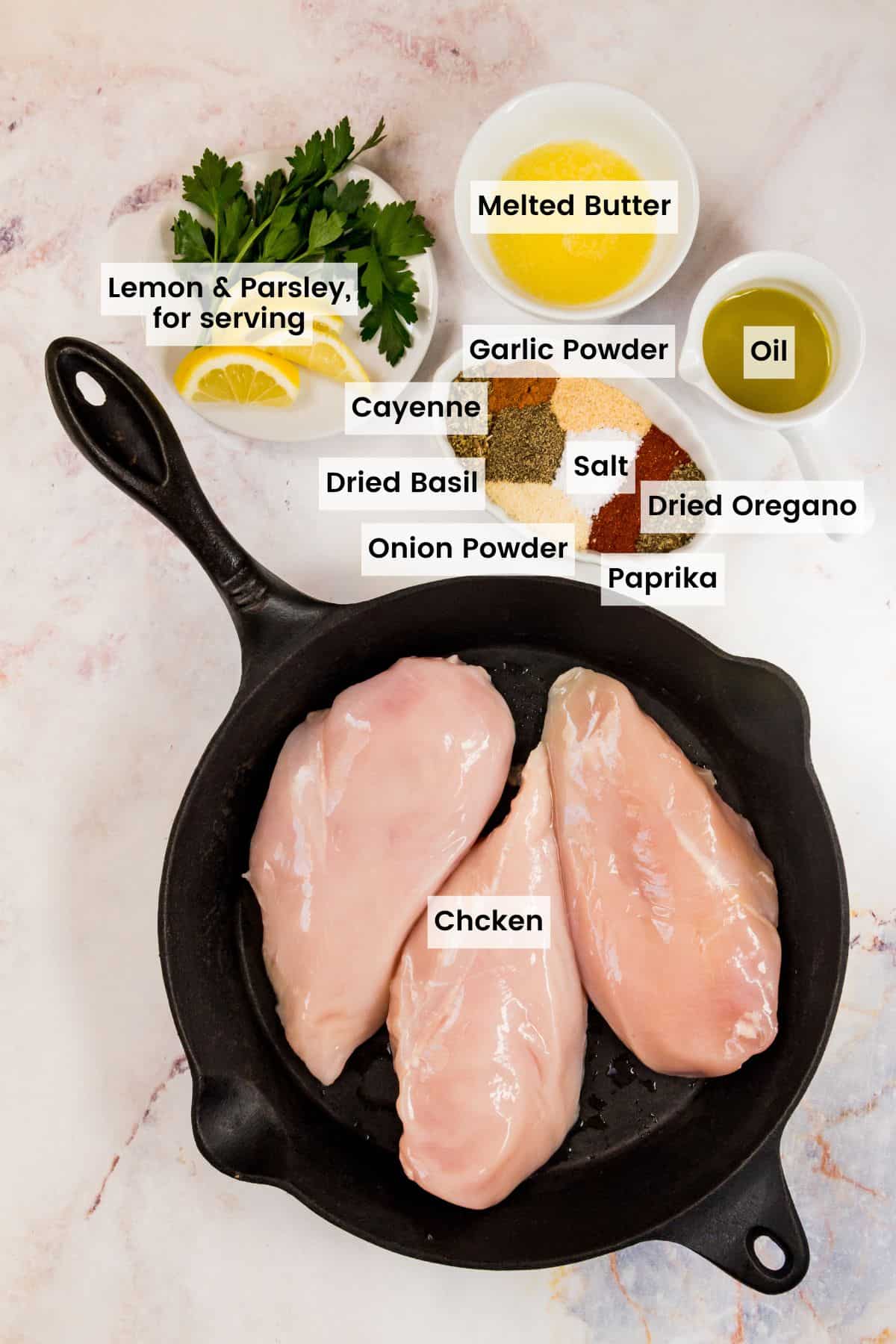 The ingredients for baked blackened chicken breasts with text labels.