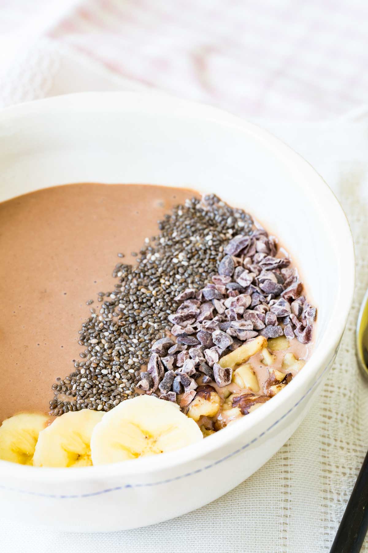 A close-up of the toppings on a chocolate smoothie bowl.