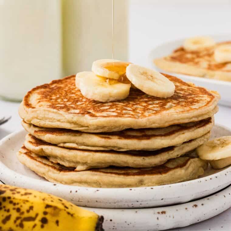 A stack of gluten free banana pancakes on a white plate