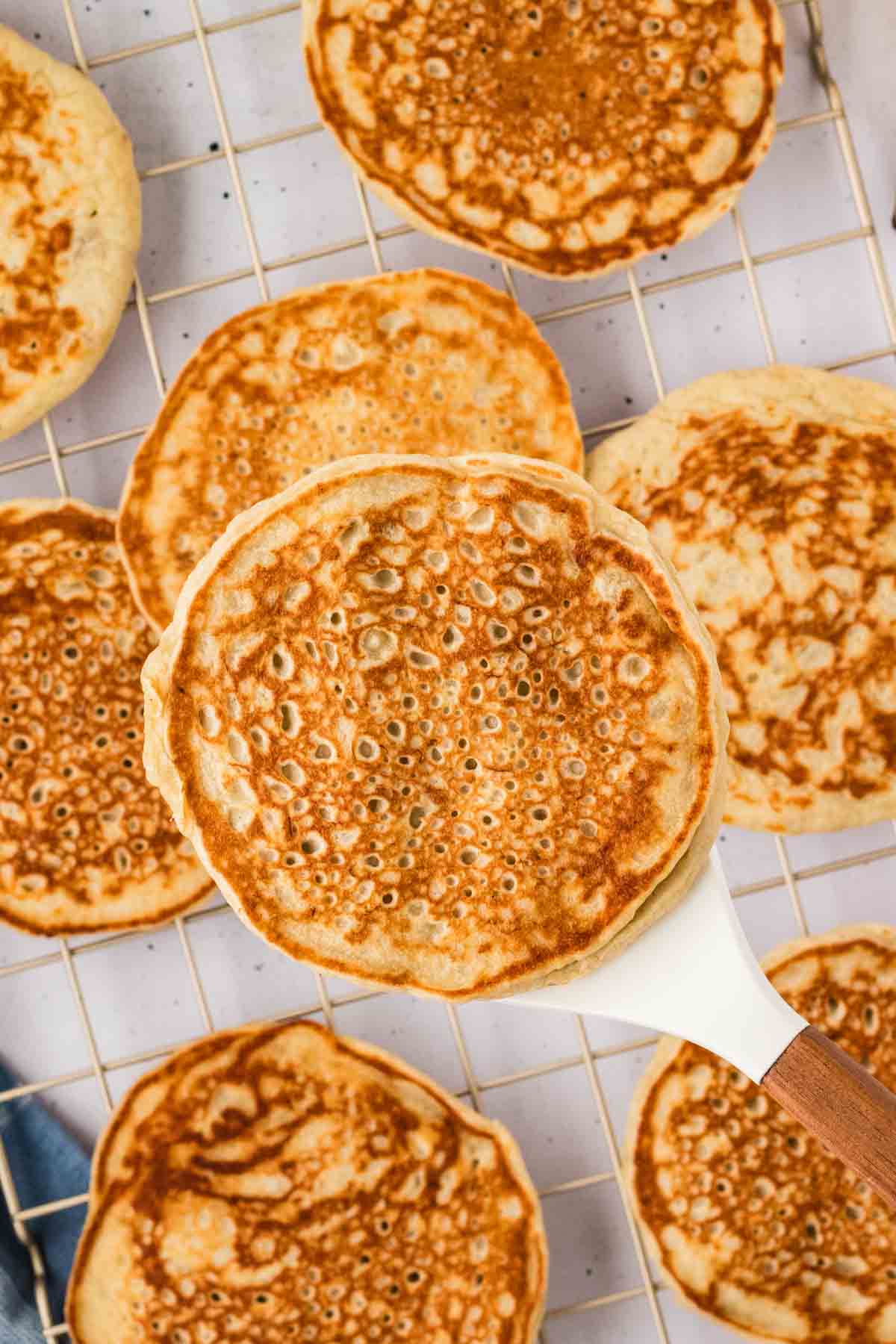 Overhead view of a spatula holding a banana pancake