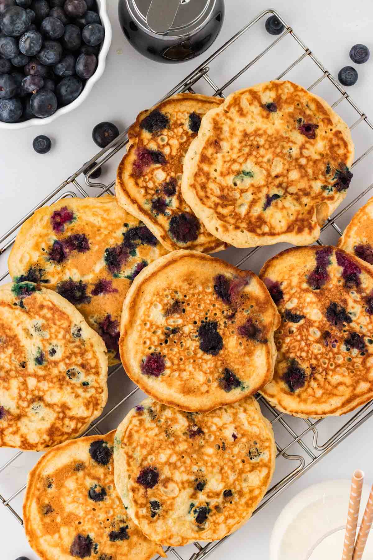 Overhead view of gluten free blueberry pancakes on a wire rack