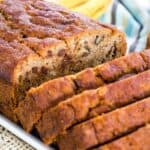 A sliced loaf of banana bread with chocolate chips and walnuts with text overlay that says "Gluten Free Oatmeal Banana Bread".