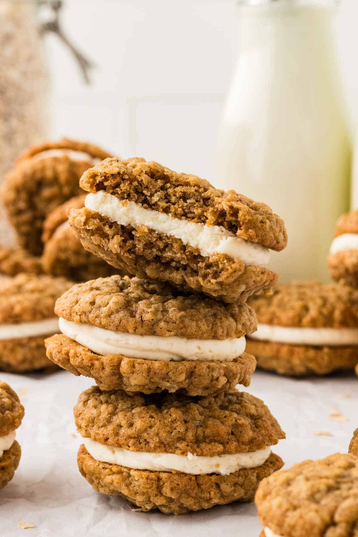 A stack of three gluten free oatmeal cream pies, one with a bite missing