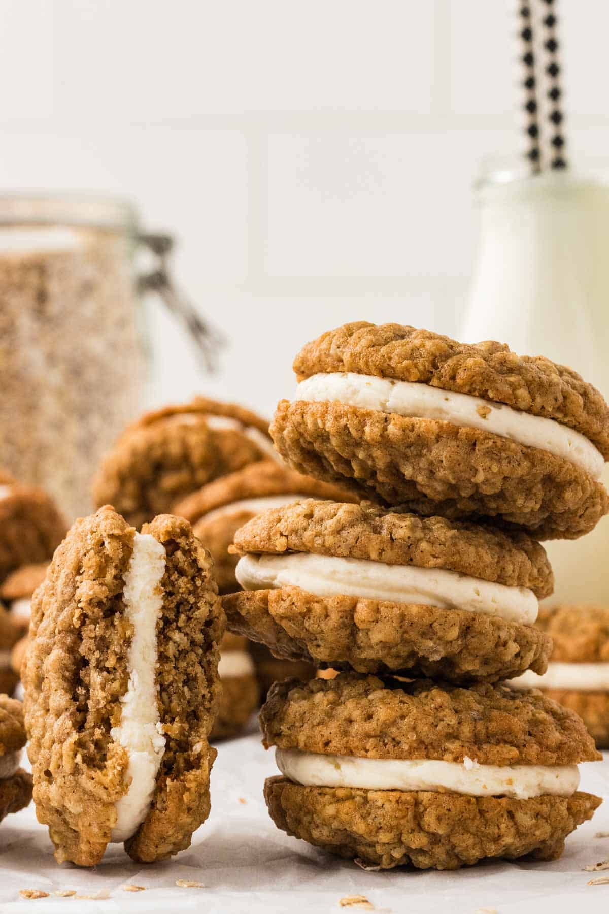 Three oatmeal cream pies stacked on top of each other with one leaning next to it. 