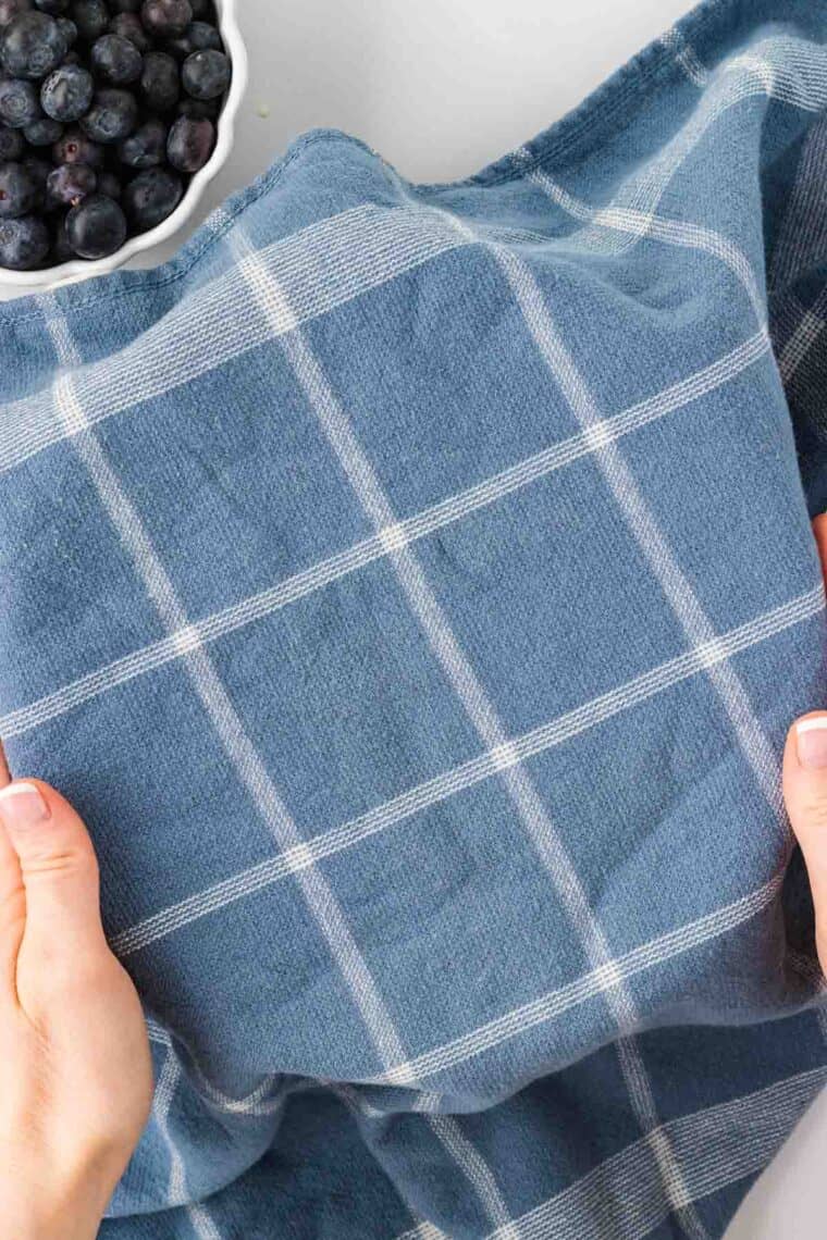 A kitchen towel covering a bowl of pancake batter