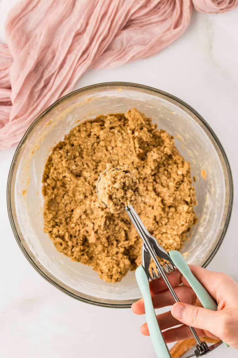 Oatmeal cookie dough in a dough scooper