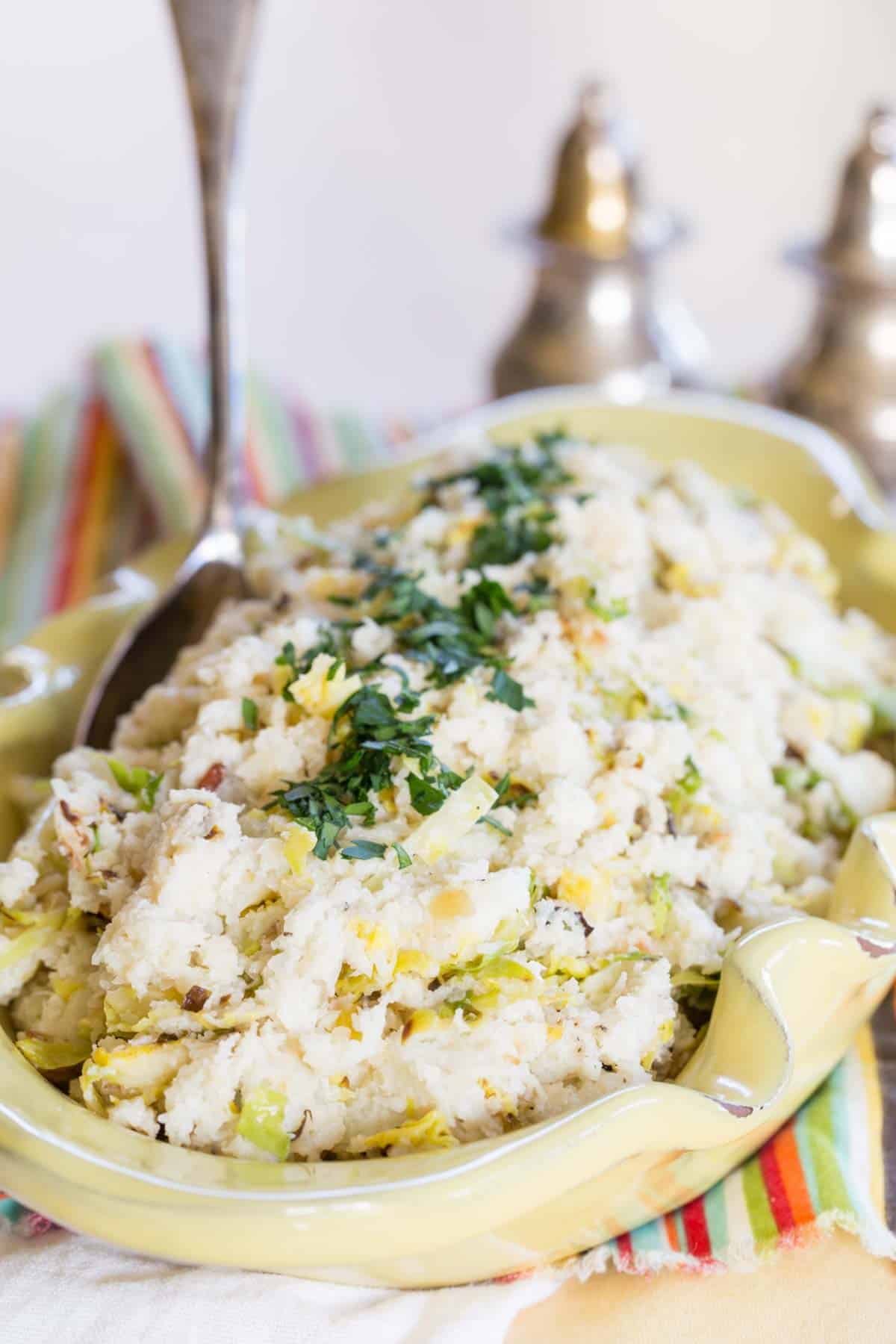 Addition of mashed cauliflower with a serving spoon in it.