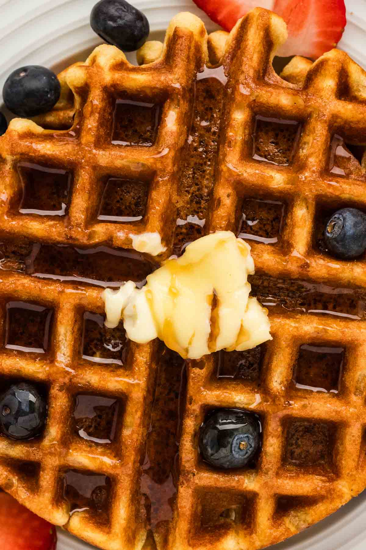 Close up of butter, syrup, and blueberries on gluten free buttermilk waffles