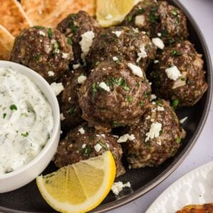 A plate of Greek meatballs with tzatziki and pita