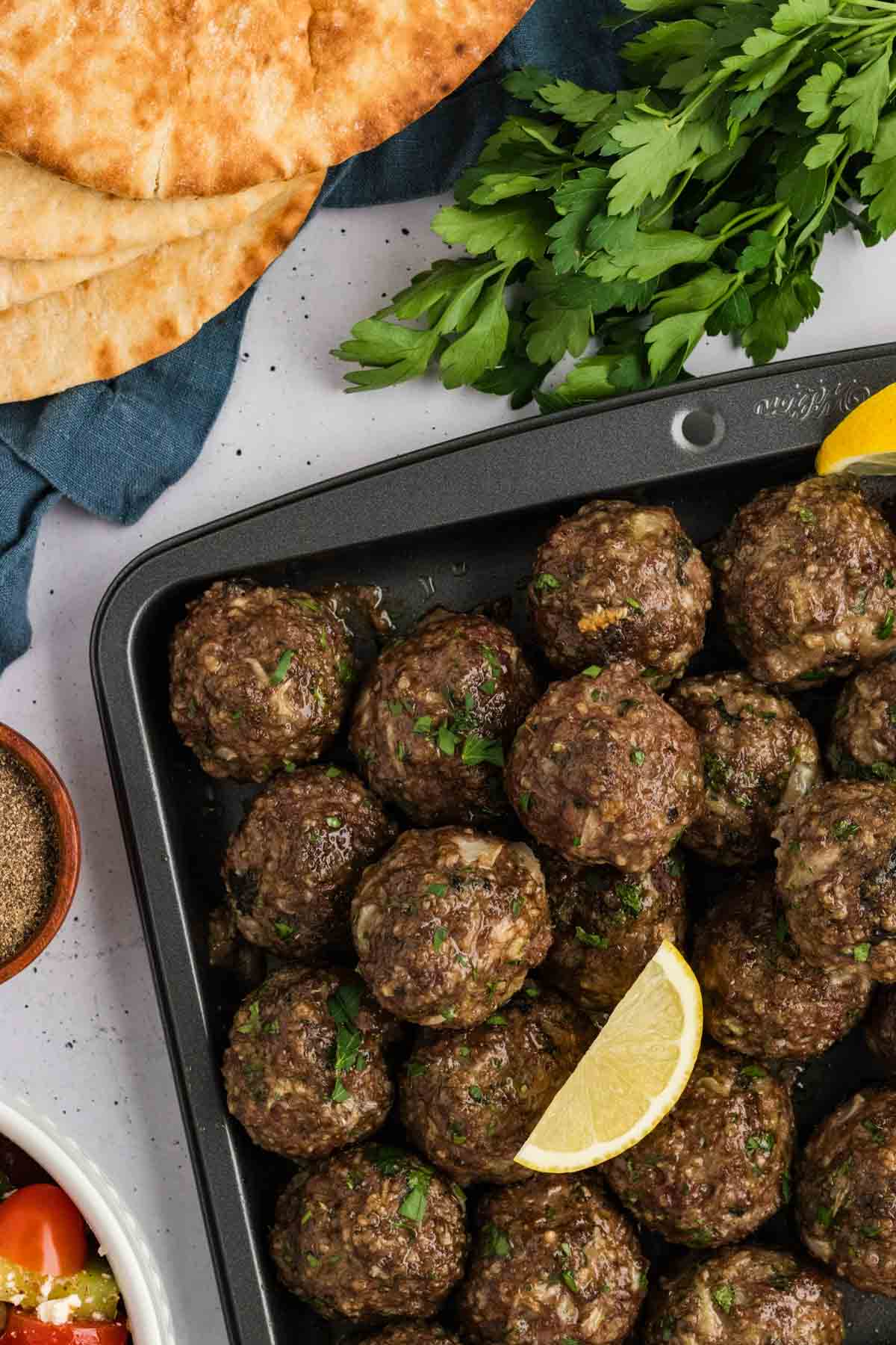 Greek meatballs on a baking sheet