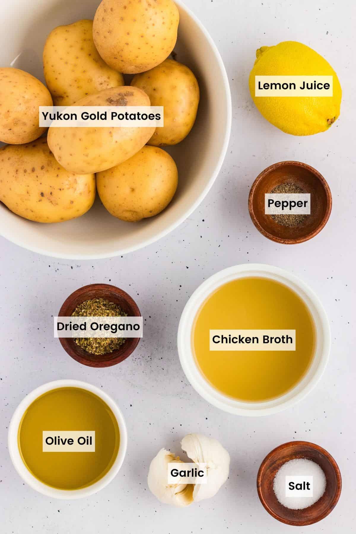 Potatoes are baked in a lemony, garlicky broth until golden on the outside and soft on the inside in this Greek Potatoes recipe. Overhead view of ingredients needed to make Greek potatoes