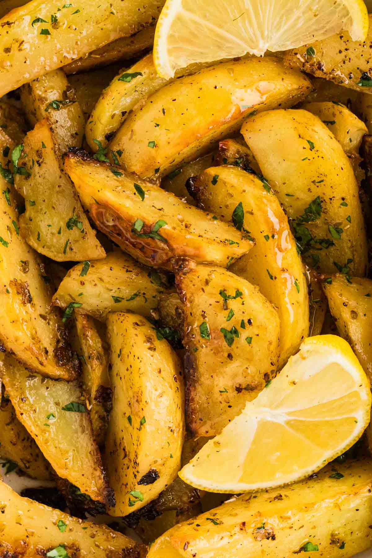 Potatoes are baked in a lemony, garlicky broth until golden on the outside and soft on the inside in this Greek Potatoes recipe. Close up of Greek potatoes