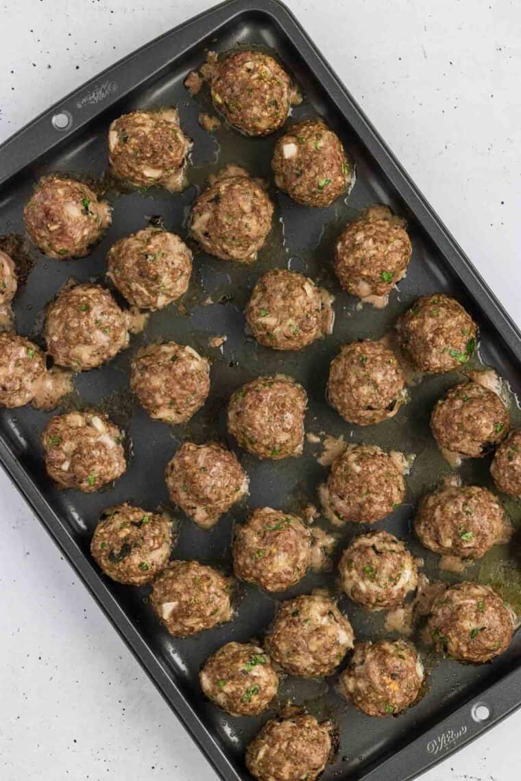 Overhead view of Greek meatballs on a baking sheet