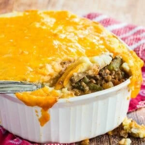 Hey serving spoon in a casserole dish of low carb shepherds pie.