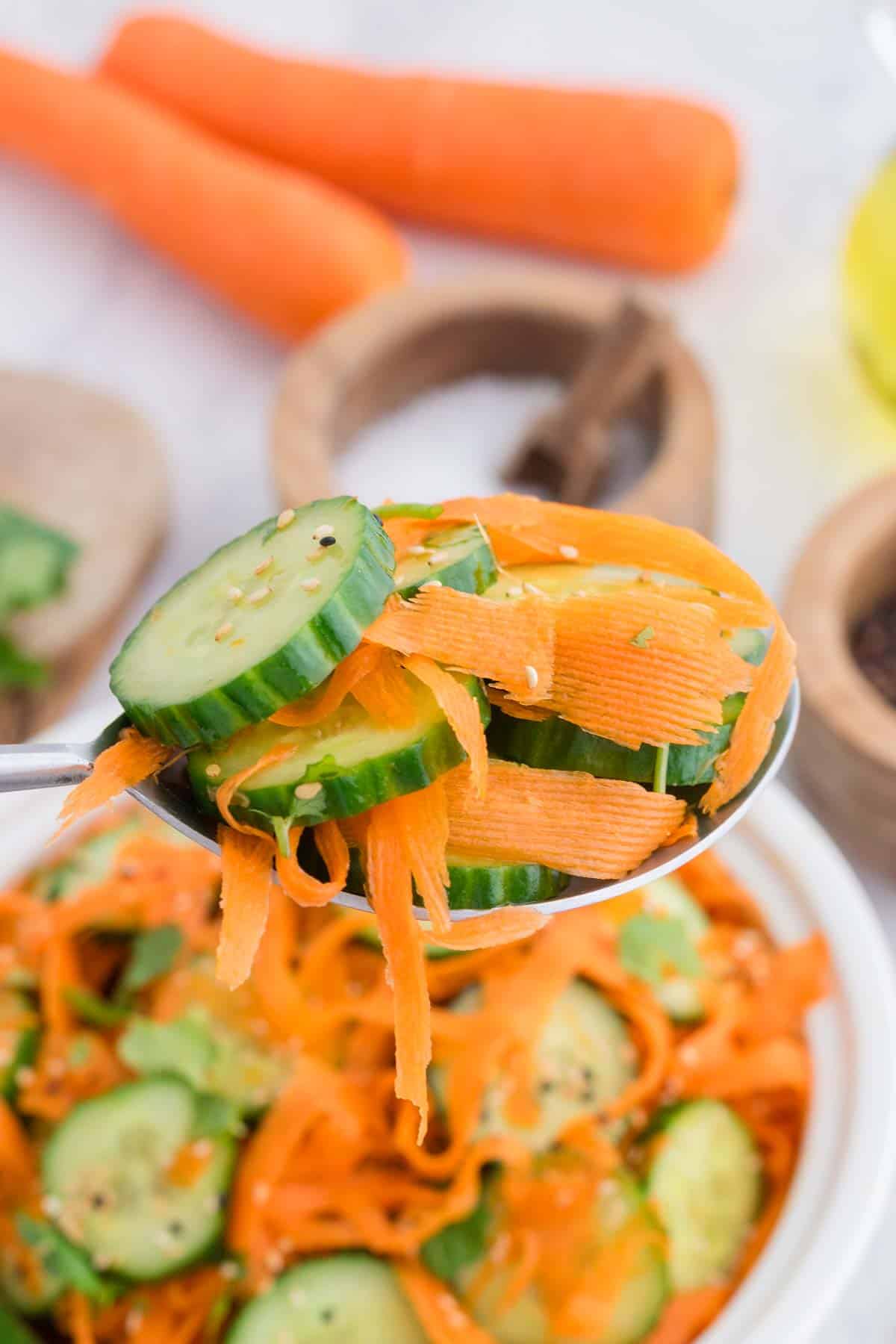 Close up of a spoonful of Asian carrot cucumber salad