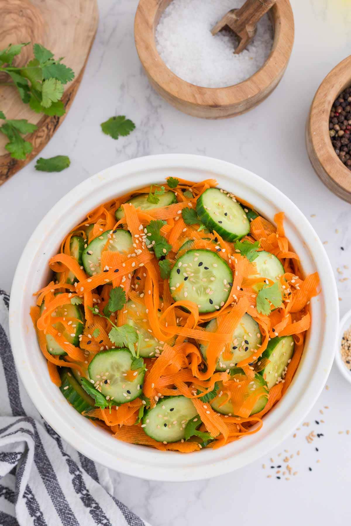 Overhead view of a bowl of Asian carrot cucumber salad