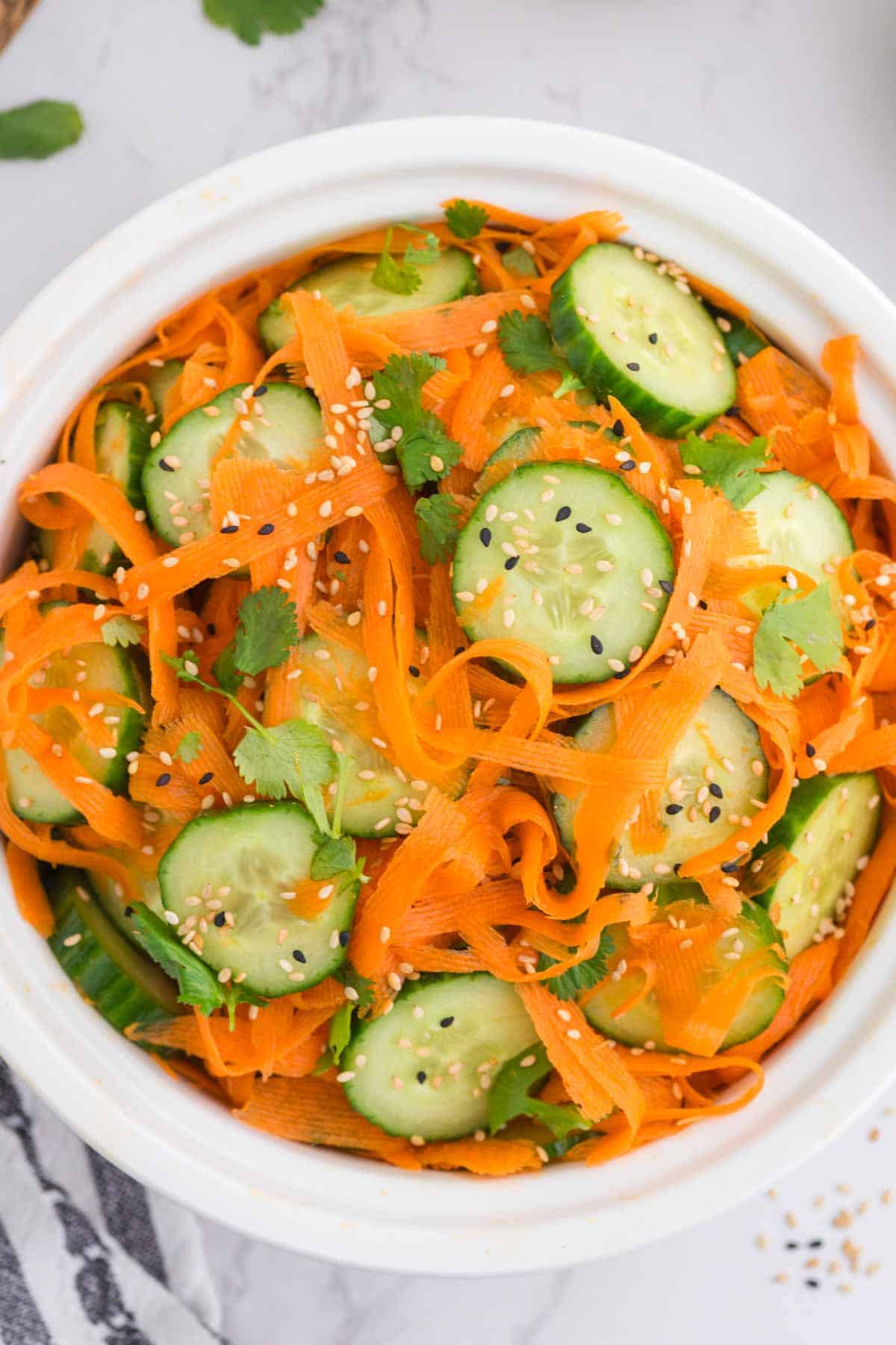 Overhead view of a bowl of Asian carrot cucumber salad